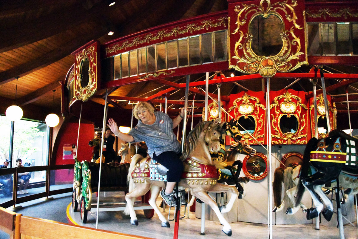 085 Bernice Mettenbrink says hi as she rides the carousel.jpg